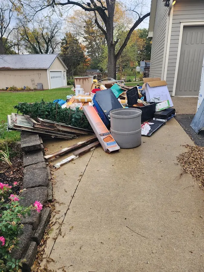 Dumpster being loaded with debris for Estate Cleanout Dumpster Rental in New Ulm